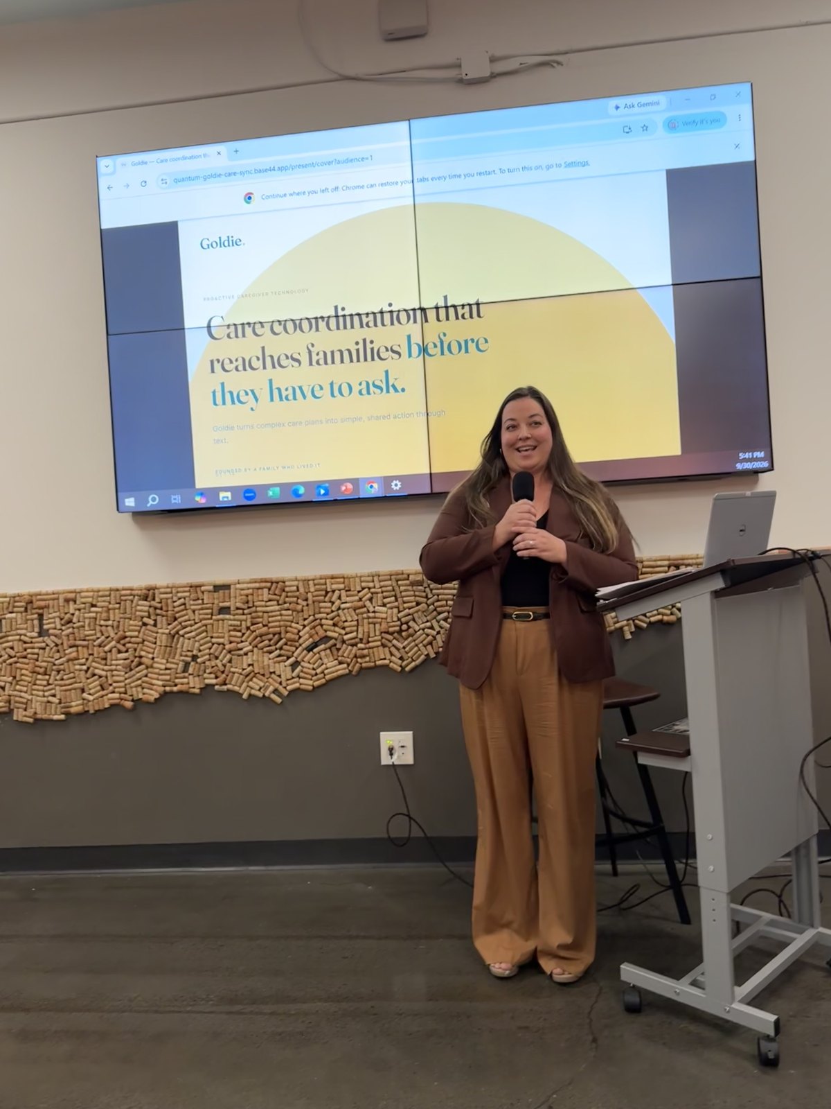 Katelyn Thompson presenting Goldie with a microphone at Atlanta Tech Park.